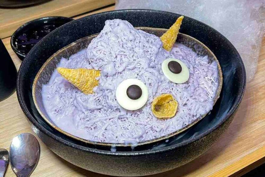 A purple dessert designed to look like a cute cartoon monster.