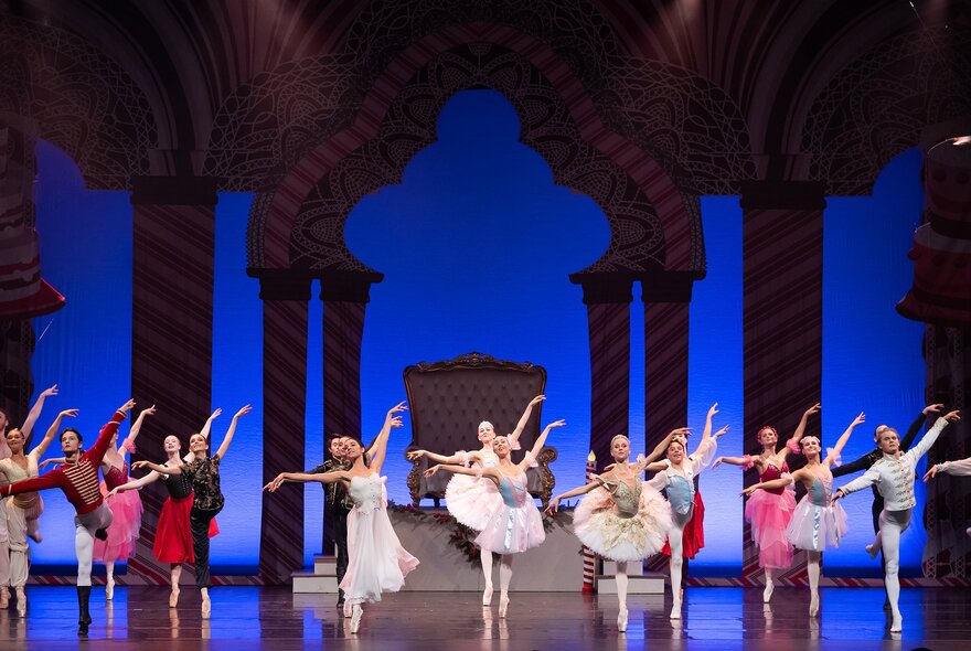 Rows of ballet dancers in tutus performing on stage.