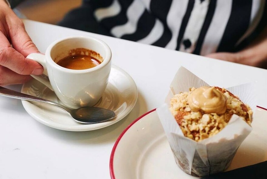 Cup of coffee and an iced muffin.