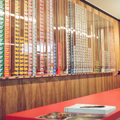 The film wall and red counter inside the shop WALKENS House of Film.