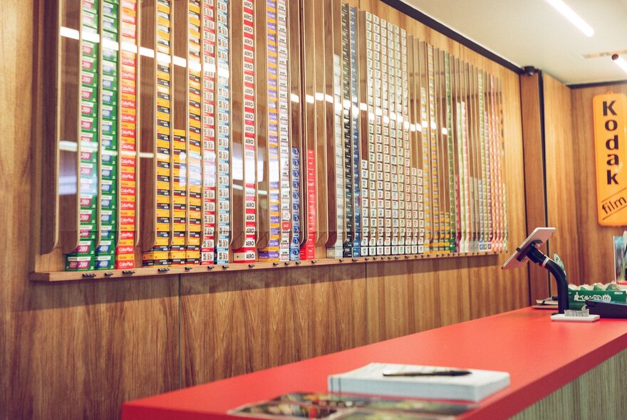 The film wall and red counter inside the shop WALKENS House of Film.