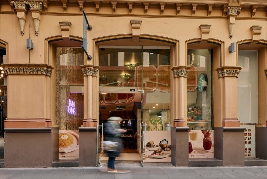 Exterior of an old building with blurred motion person in the front. 