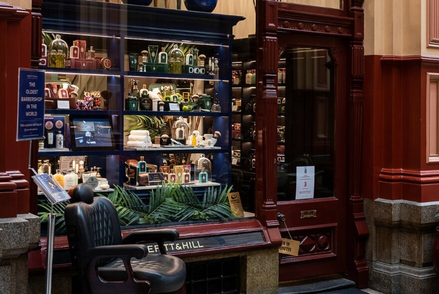 Exterior of Truefitt & Hill store showing the window display and a barber's chair out the front.