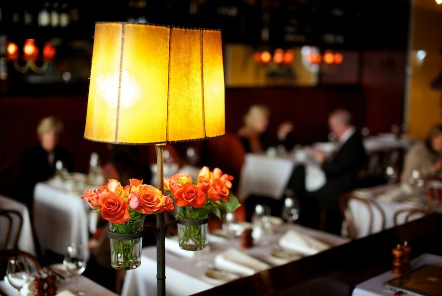 Table lamp with roses in an upmarket restaurant.