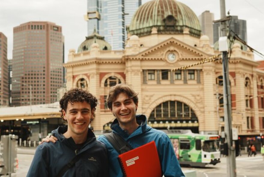 To tour leaders in front of Flinders St Station.