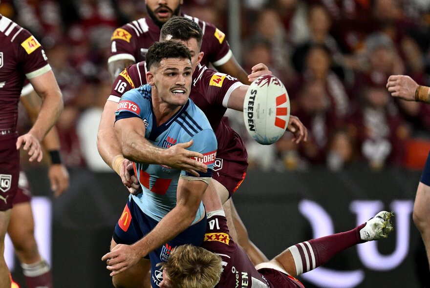 NRL State of Origin players on the field, playing rugby.