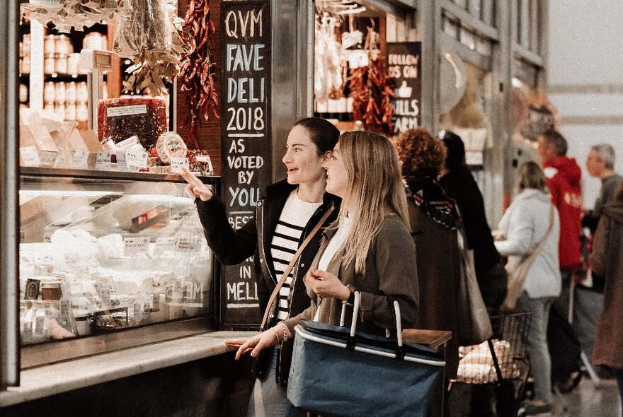 People lined up at a cheese stall at Queen Victoria Market.