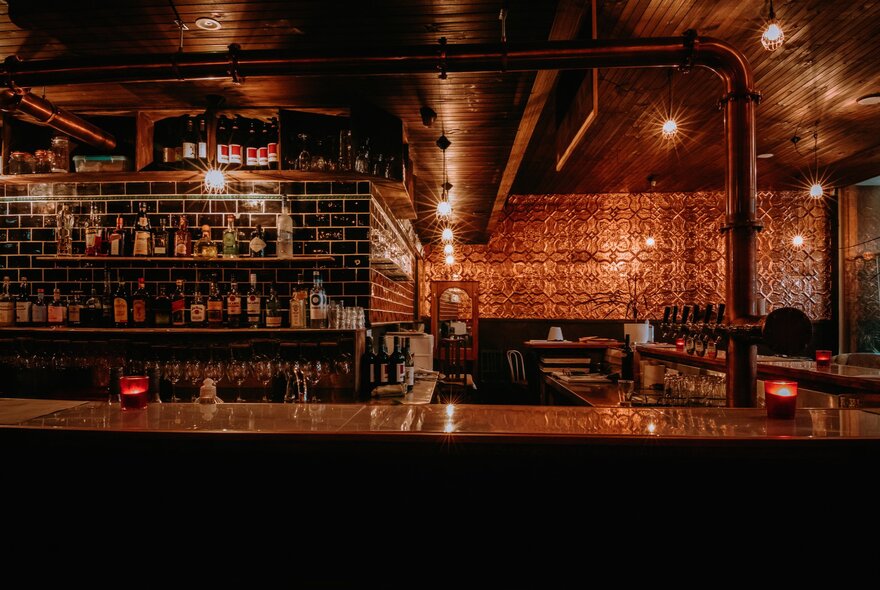ar interior with shelves of bottles and overhead lighting.
