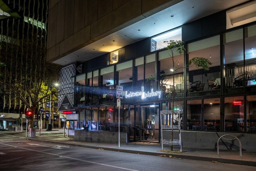 A night view of an exterior of a restaurant. 