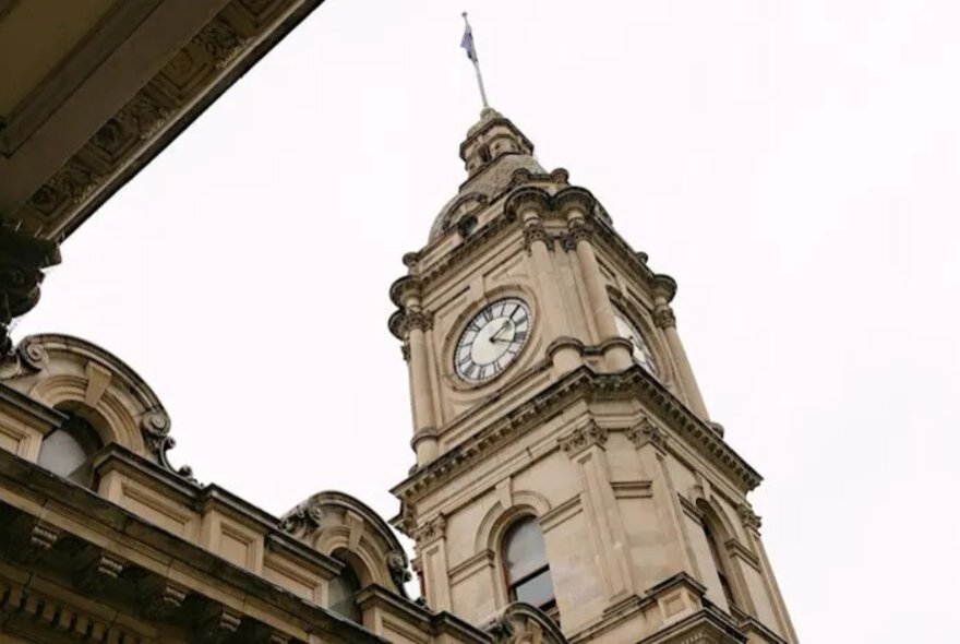 Melbourne Town Hall clock tower, highlilghting Victorian architectural arches and pillars.