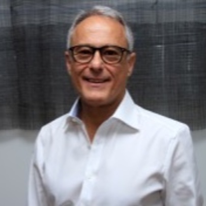 Middle-aged man wearing a white shirt and glasses.