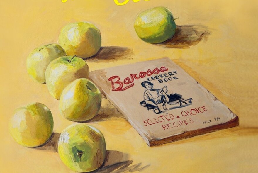 A painting with scattered pale green apples and a Barossa cook book.