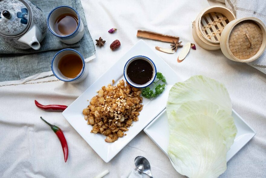 A plate of Chinese food and tea.