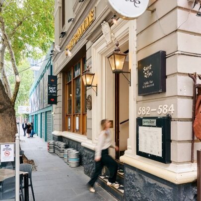 Exterior of Saint & Rogue, a grand, heritage-style building with light-coloured masonry and classic architectural details.