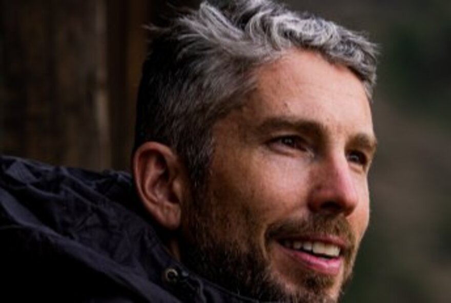 Close-up of author Lance Richardson smiling and looking off-camera.