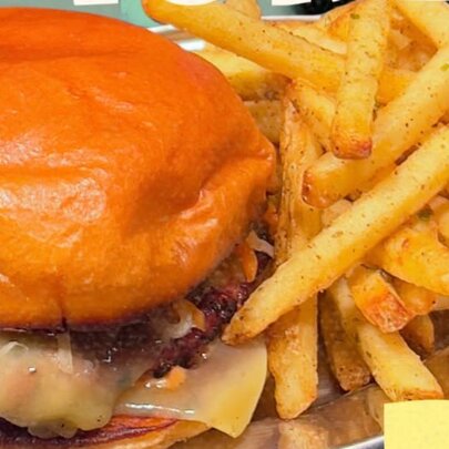 Close up of a burger with fries.