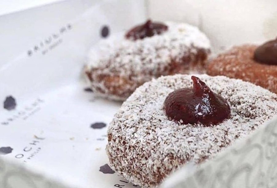 Three lamington-style doughnuts in a box.