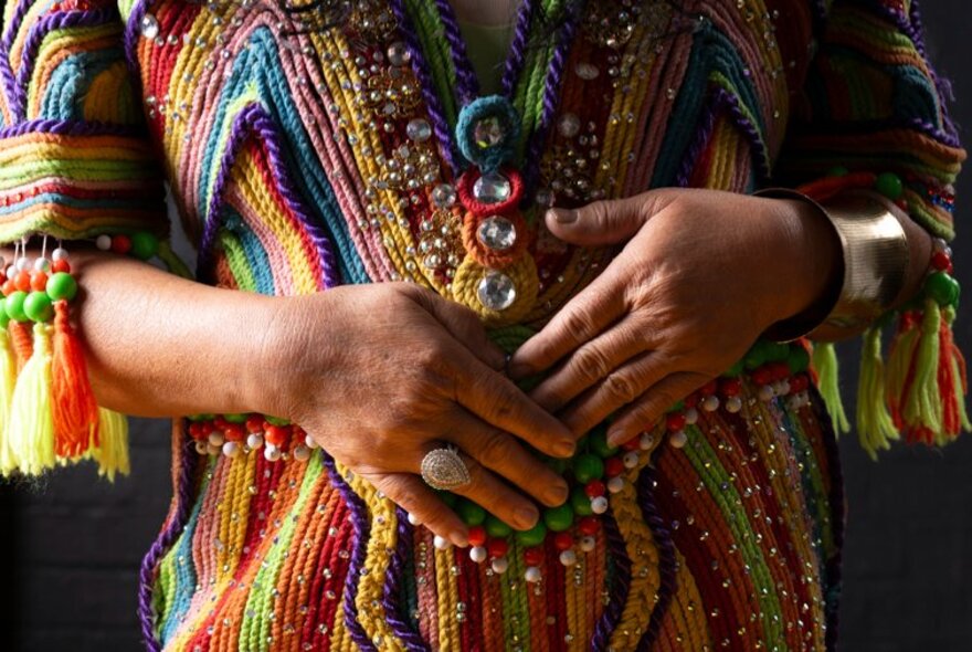An intricately woven and brightly coloured traditional Filipino dress as seen on the torso of a woman.