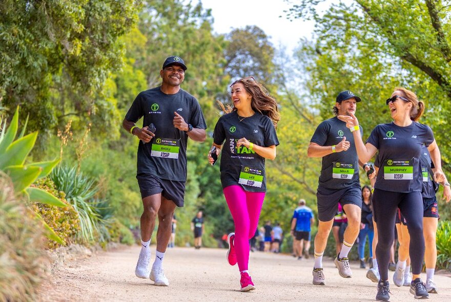 A group of people enjoying a fun run through Melbourne's Botanic Gardens.