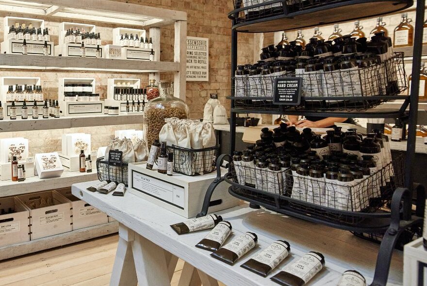 A beauty boutique display of hand creams with brown and cream packaging.