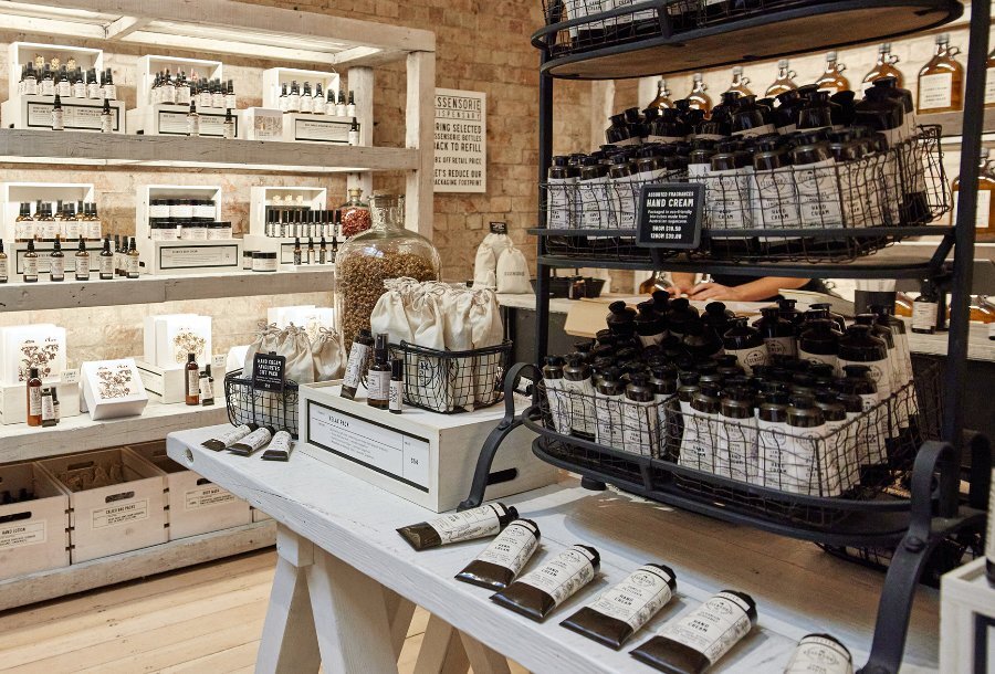 A beauty boutique display of hand creams with brown and cream packaging.