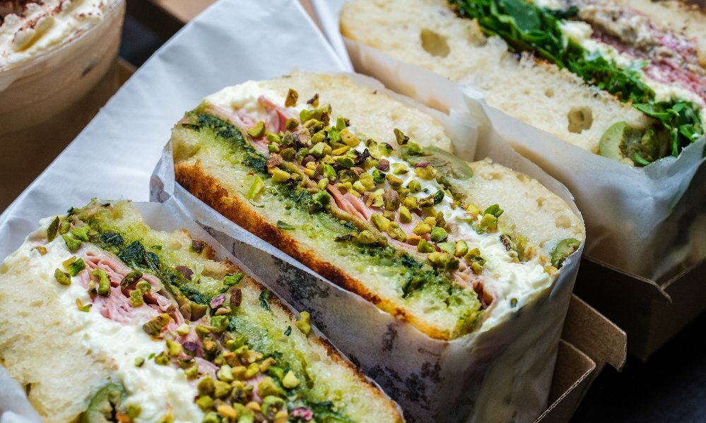 A focaccia sandwich with pistachio and meat inside