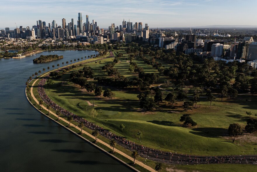 Aerial view of the city of Melbourne and the Yarra River, with large areas of green parkland in the foreground.