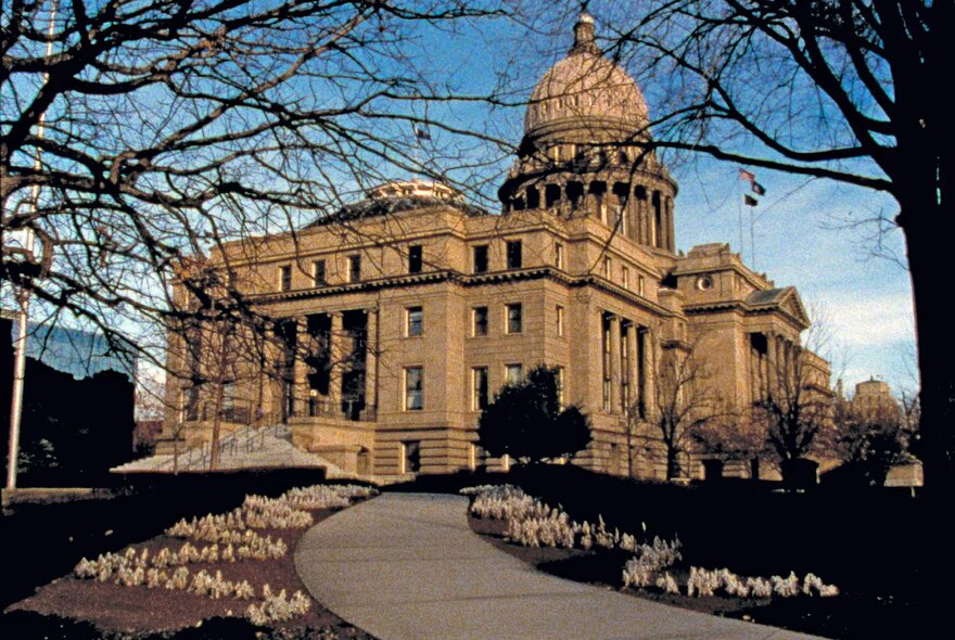 An American city hall type building with a dome and a path winding up to it. 