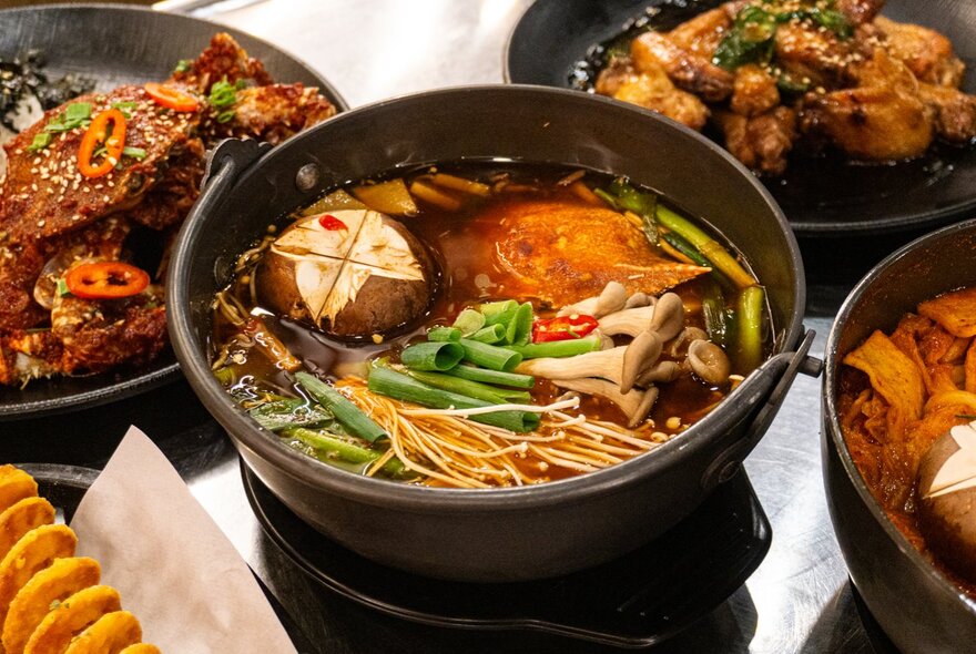 Dishes of Korean food with meat and vegetables.