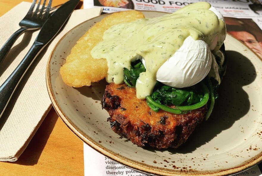 Savoury meal with spinach, hash brown and green sauce.