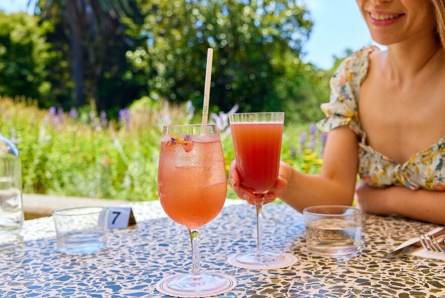 Two cocktails on a cafe table.