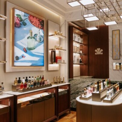 House of Creed perfumerie with tiny bottles on a centre island and arranged around the walls. 