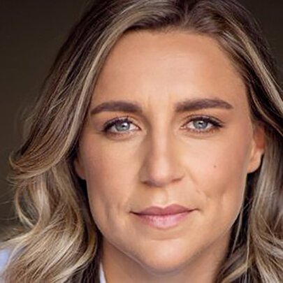 Head shot of Freya List, an Australian choreographer, with blond wavy hair framing her face.