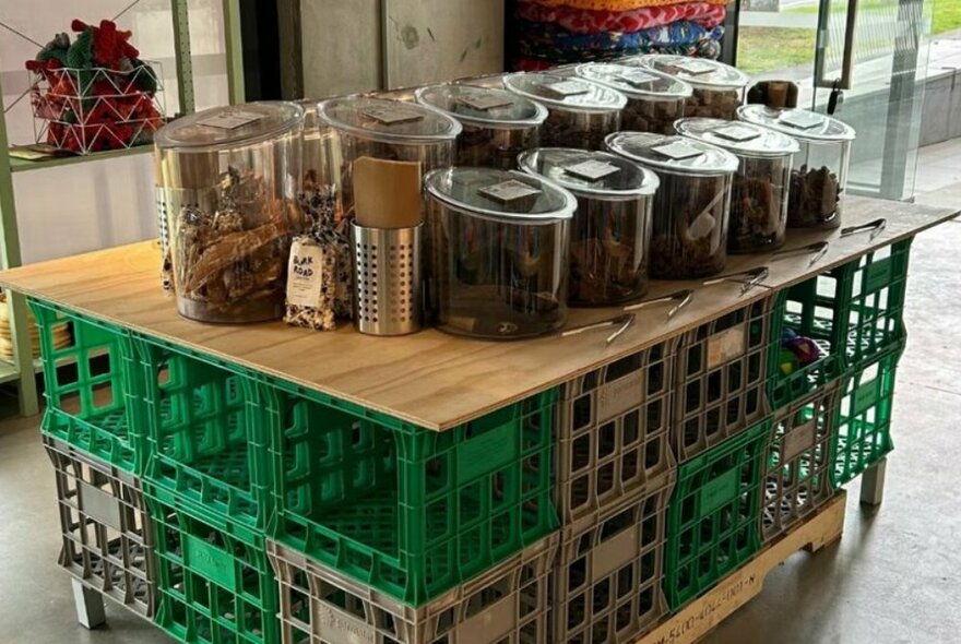 A central display table of pet treats in a pet store.