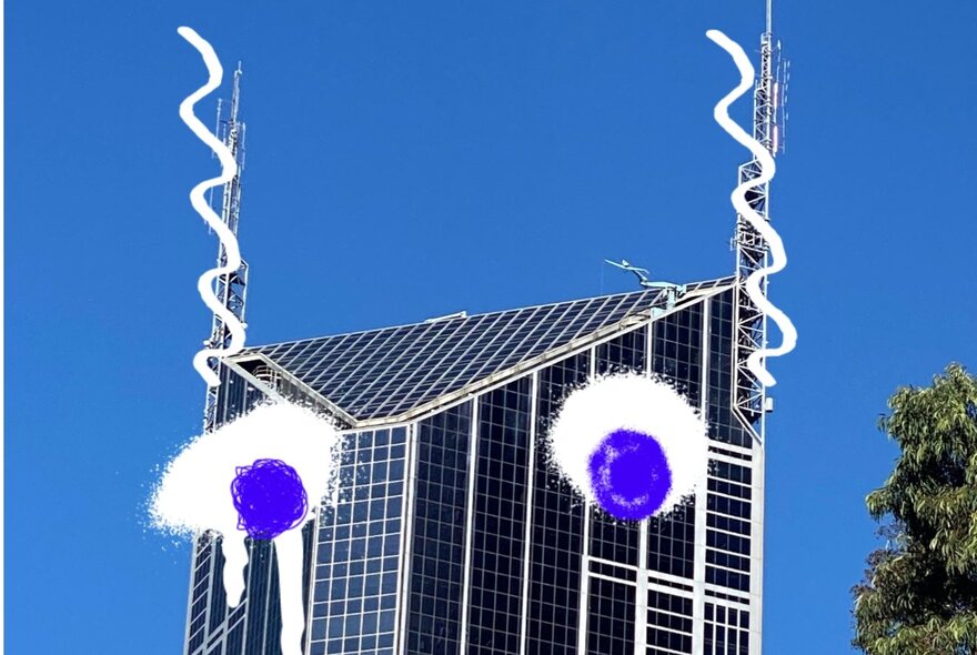 A photograph of the top of a glass-walled skyscraper with two radio towers on either side, with two eyes drawn over the top to make it look like a face.