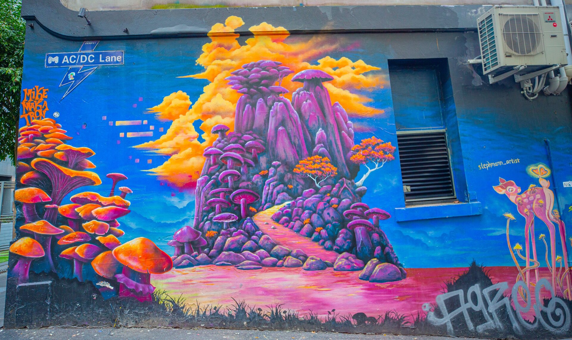 A colourful street art mural of mushrooms