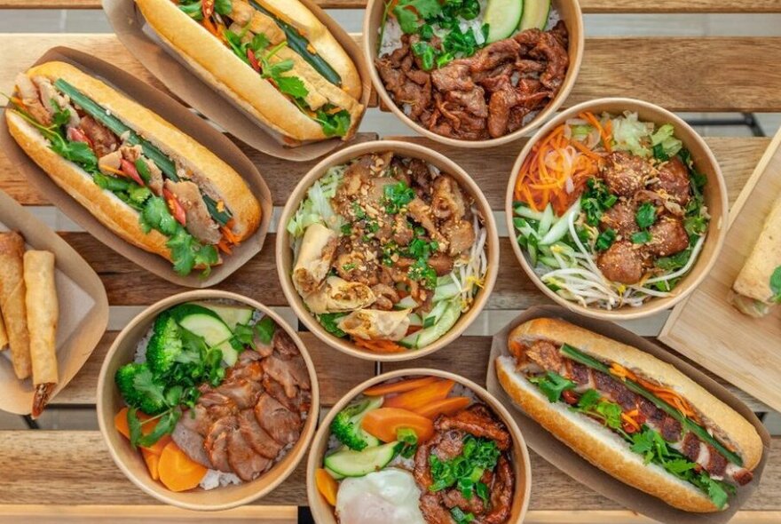 Bowls and sandwiches on a wooden table 