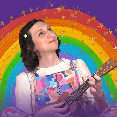 Children's entertainer playing a ukulele in front of a rainbow.