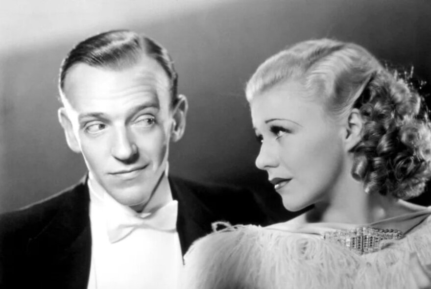 The two lead actors from the film Top Hat, looking at each other in profile; vintage movie still from the 1930s.