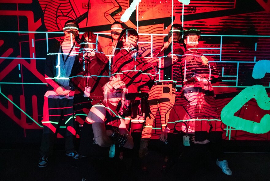 Fractured images screened onto a wall in a dark venue.