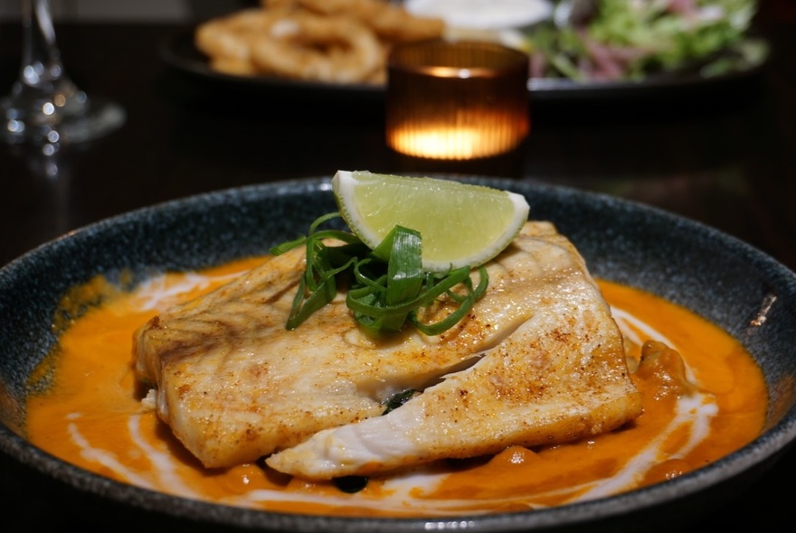 Mexican fish dish with lime garnish.