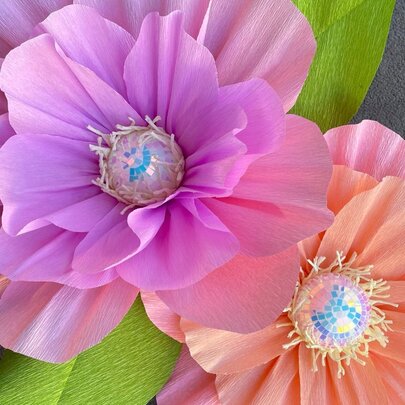 Two oversized hand made paper flowers.