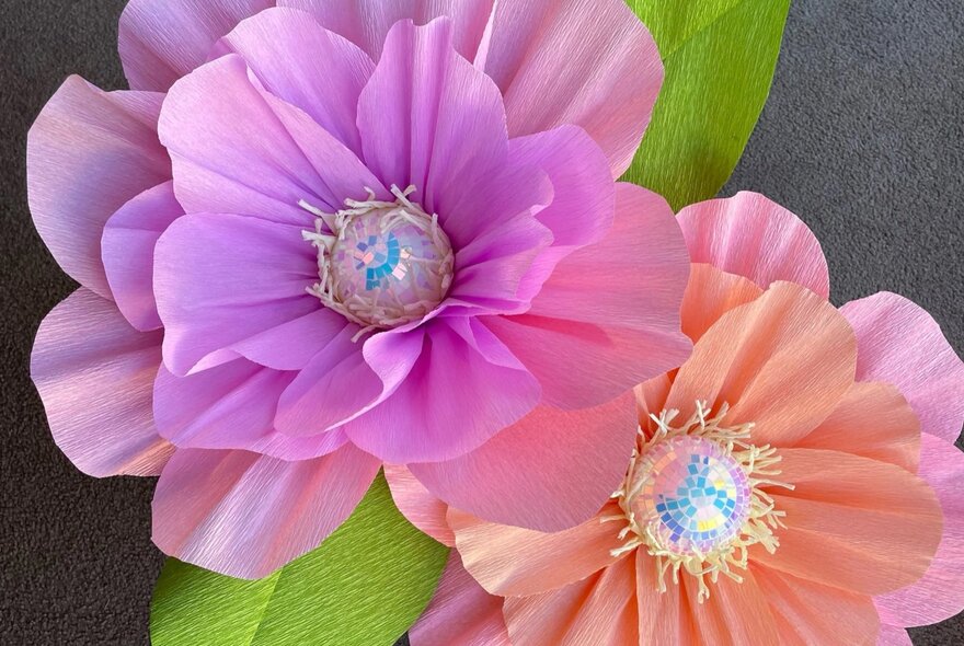 Two oversized hand made paper flowers.