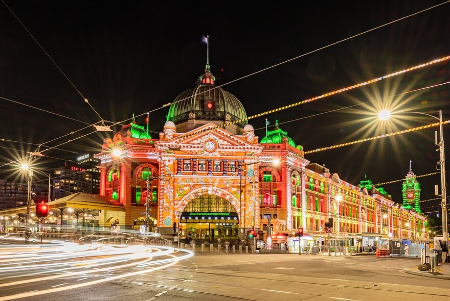 Flinders Street Station lit up with Christmas projections. 