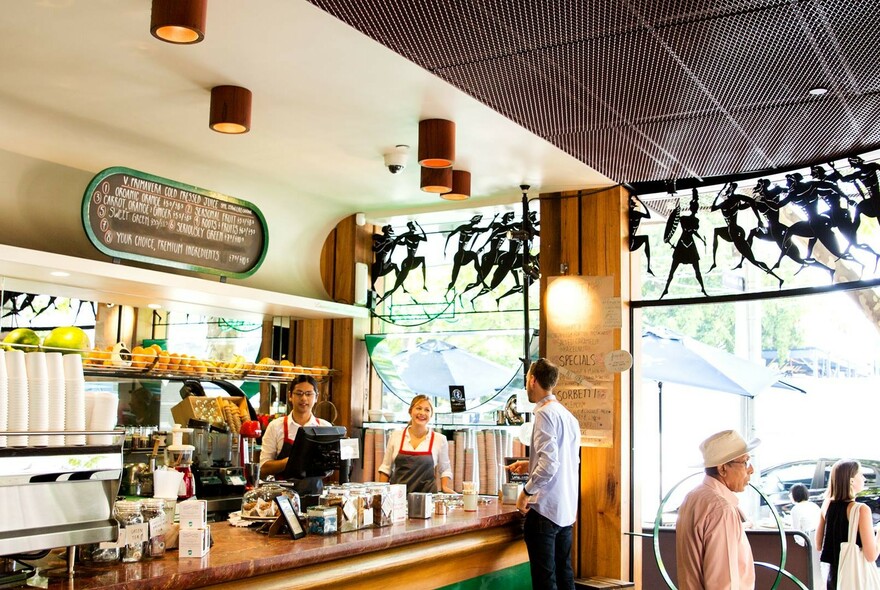 Customers at the counter inside Spring Street Grocer.