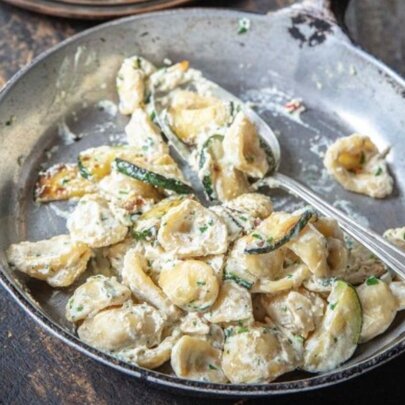 A pan of creamy gnocchi on the stove.