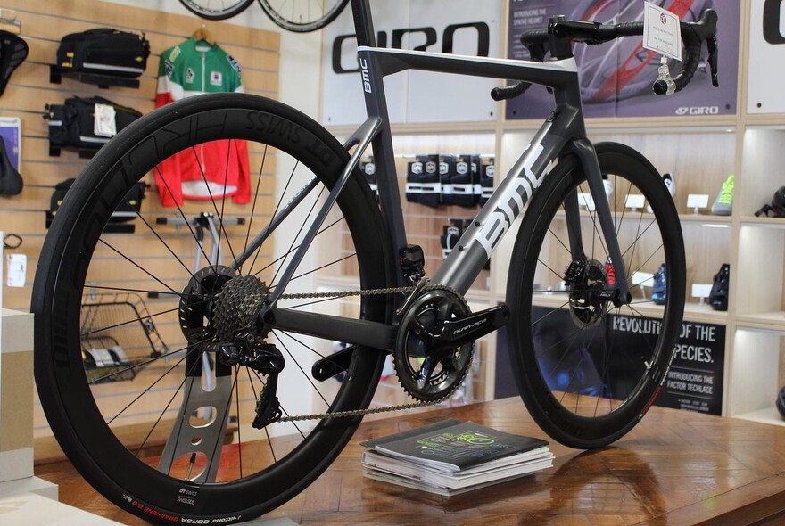 Bike standing upright on a workbench inside a bike store.
