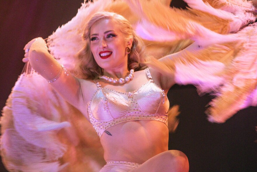 Nellie Noble, performing a feather-fan burlesque routine in a club.