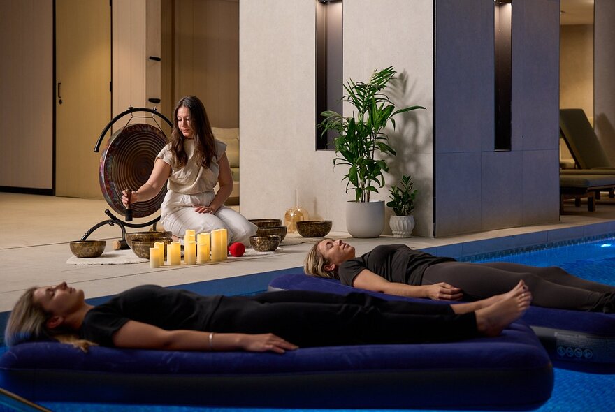 A floating sound bath, a meditative experience where participants lie on lilos on water while listening to vibrations from instruments like gongs and singing bowls. 