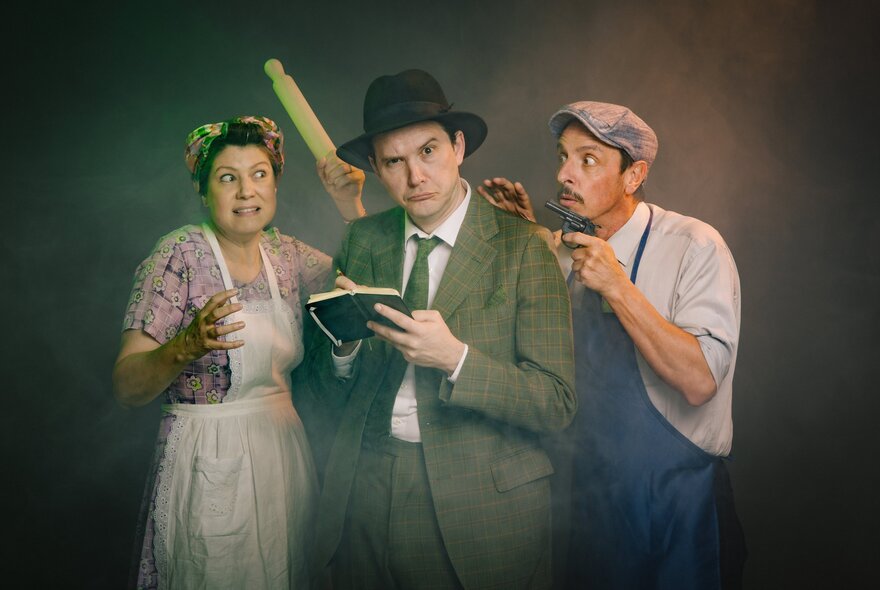 A theatre production featuring three actors dressed in mid-20th-century period costumes against a dark, moody background.